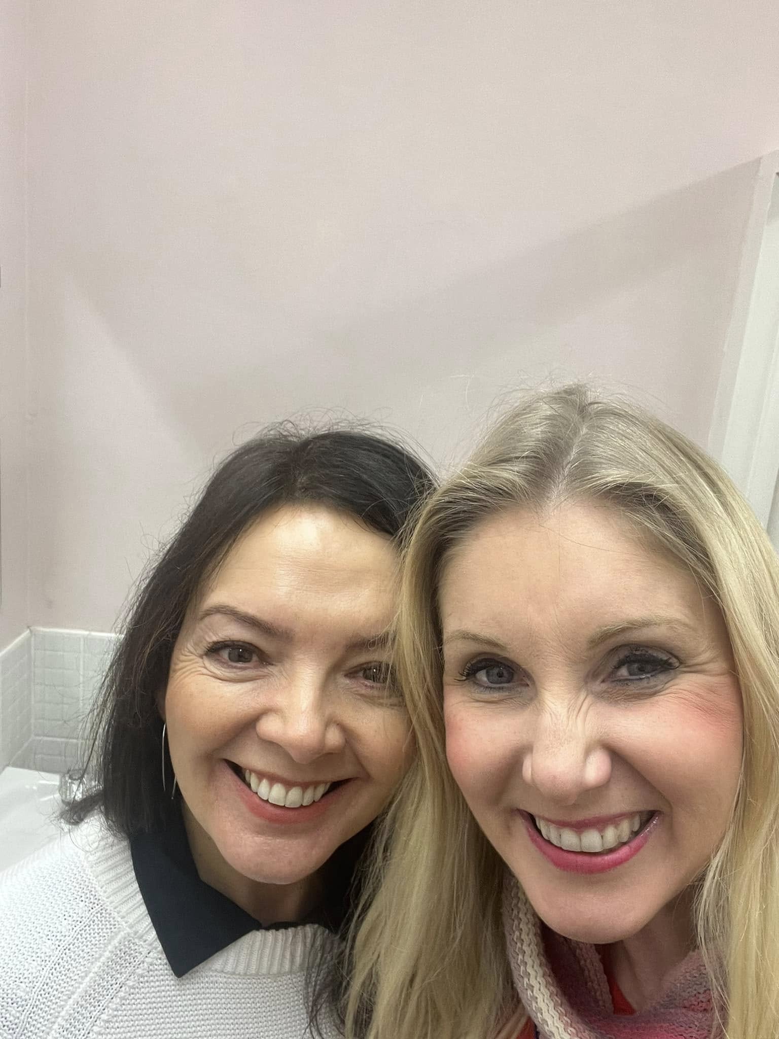 Vicky smiling with a guest